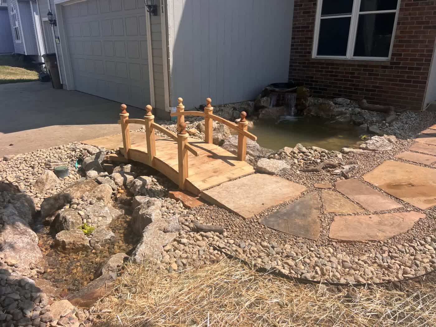 Custom backyard pond with natural stone and aquatic plants