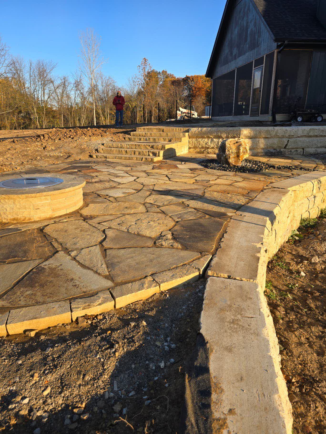 Buckskin flagstone patio with stone fire pit and bubbler fountain