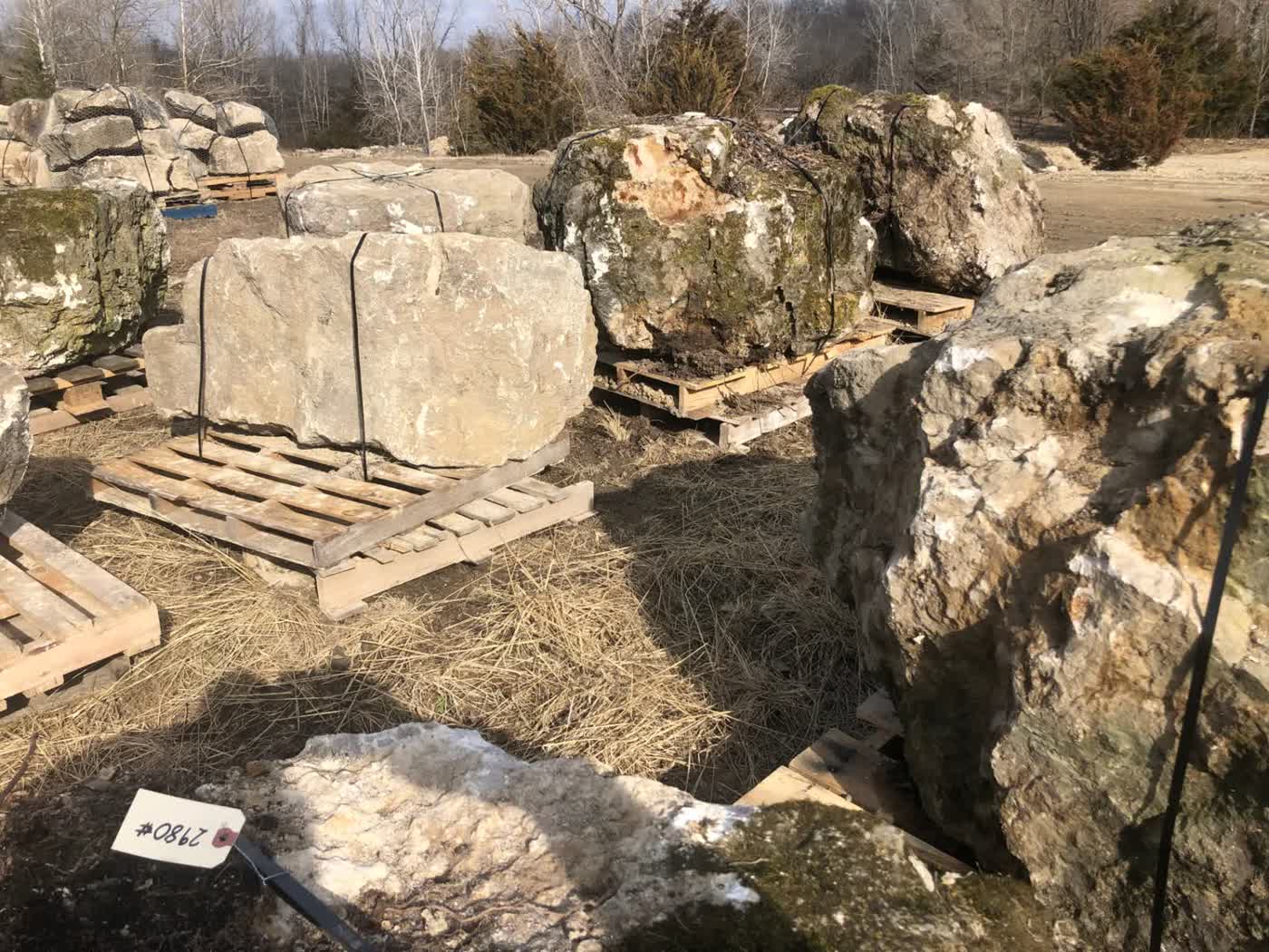 Premium mossy and weathered limestone boulders at Freedom Stone yard