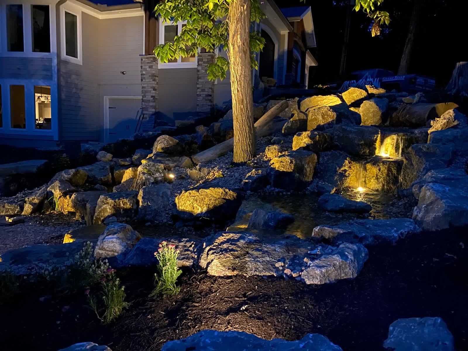 Beautifully lit pondless waterfall and landscape at night