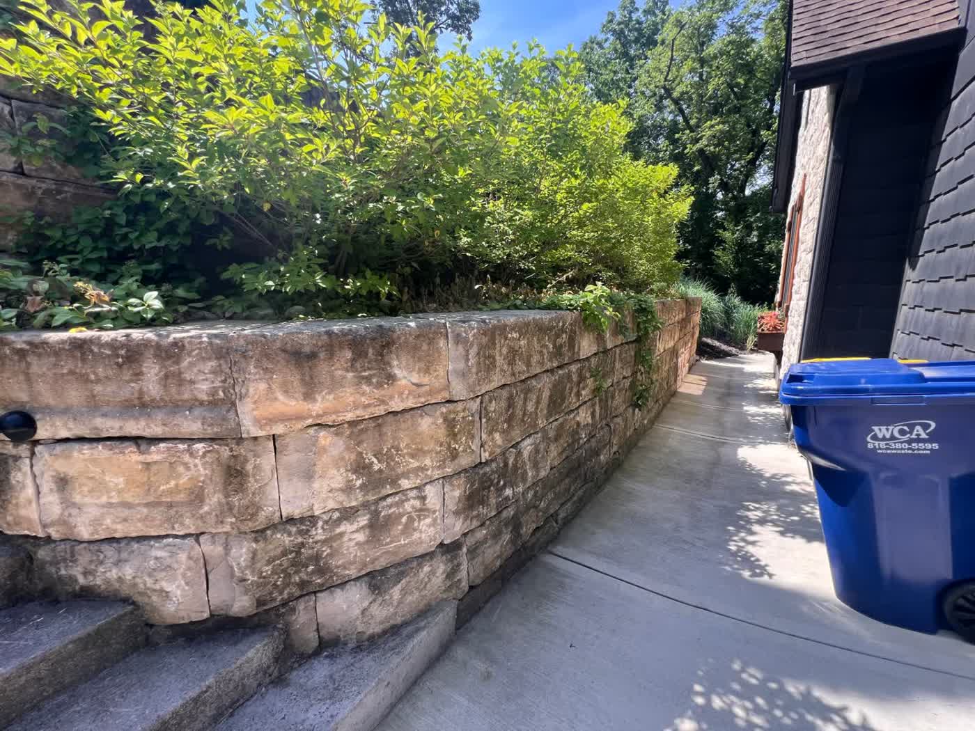 Natural stone retaining wall with landscaping