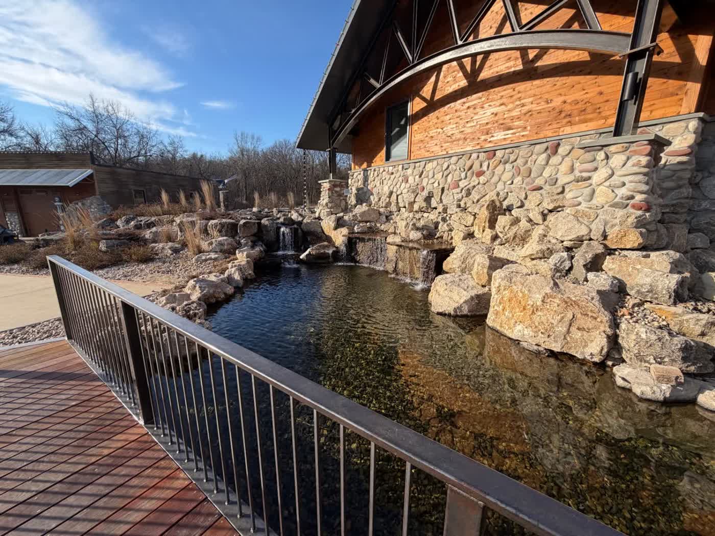 Swim pond with viewing deck and railing
