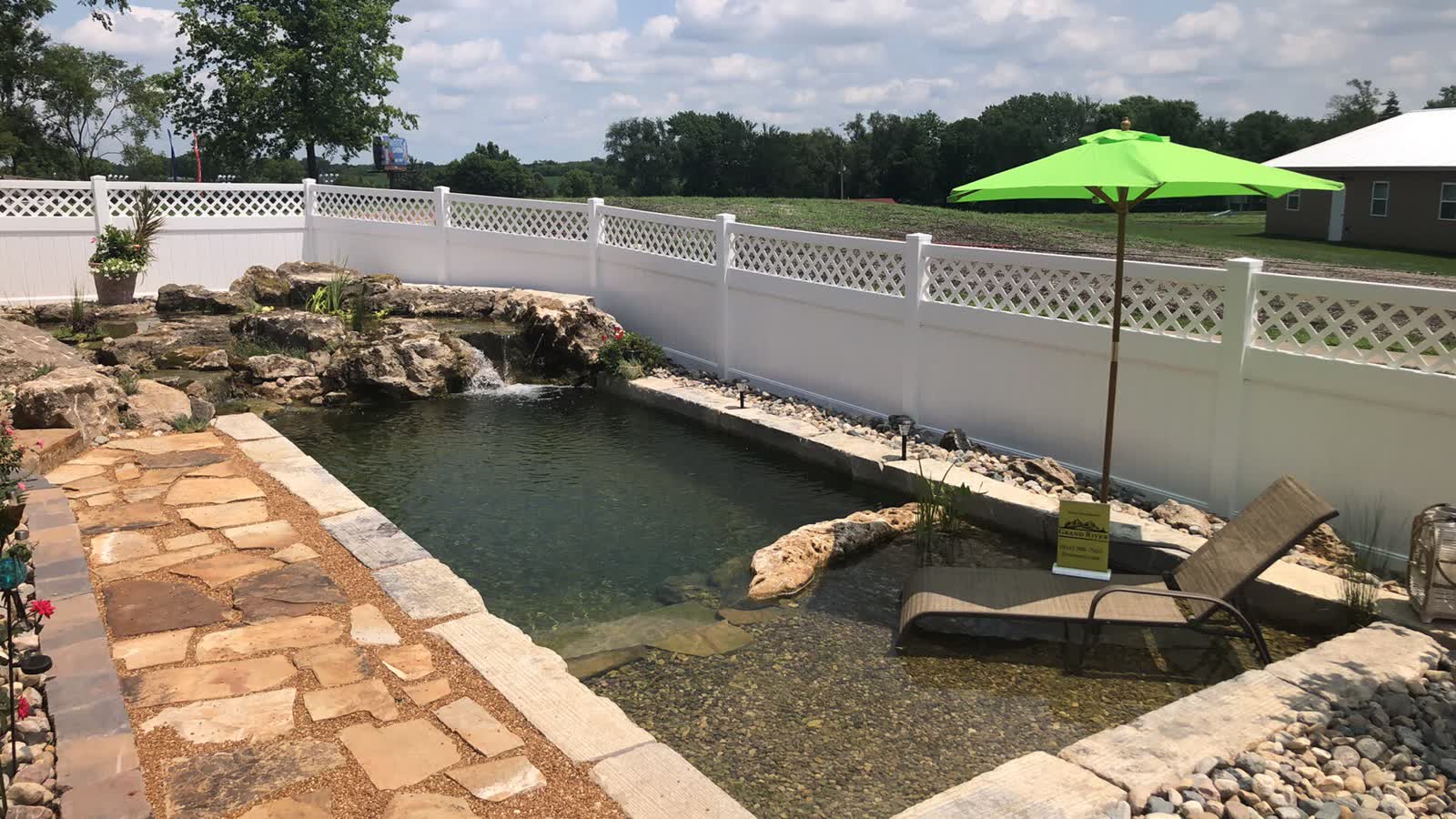 Entry-level swim pond with flagstone path and lounge area