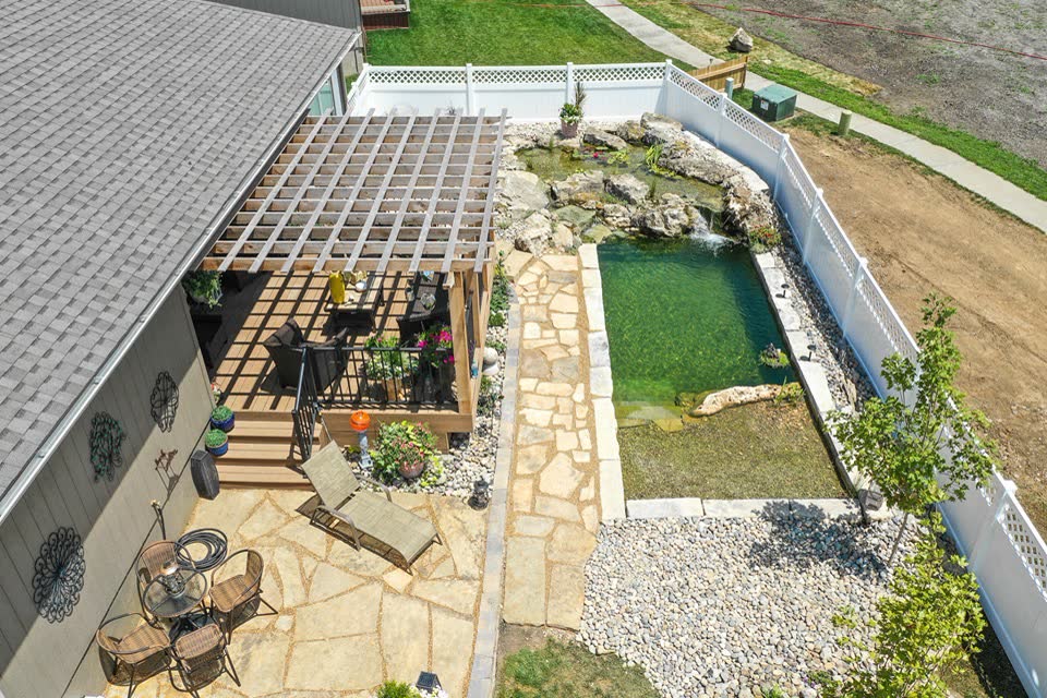 Aerial view of swim pond with pergola and flagstone patio