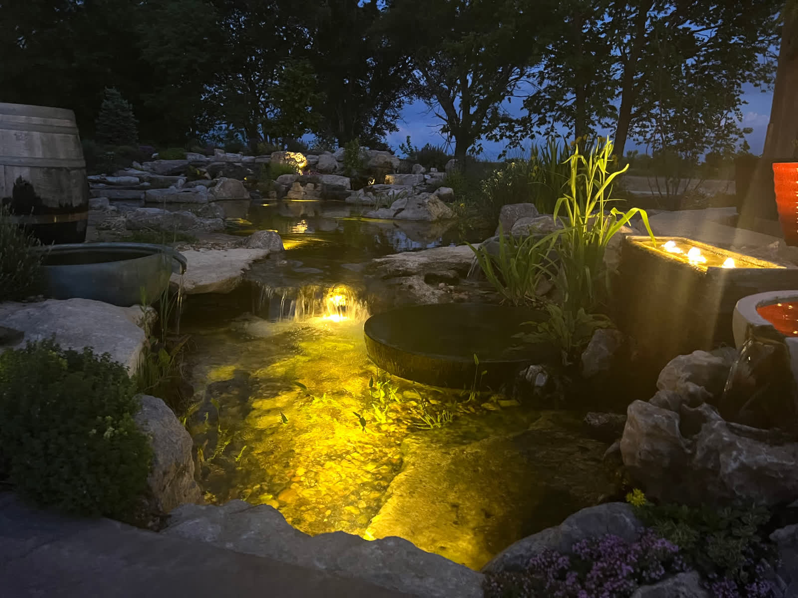 Swim pond with underwater lighting at dusk