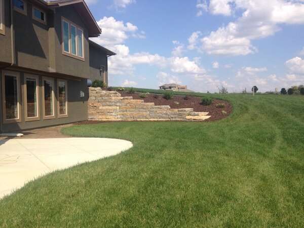 Completed land clearing project with retaining wall and proper drainage