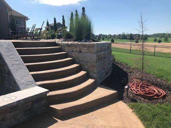stone retaining wall with stairs built by Freedom Stone + Pondscapes