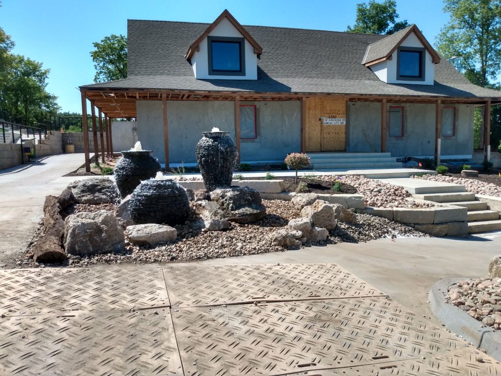 Custom fountainscape with stacked slate urn and LED lighting in landscaped courtyard